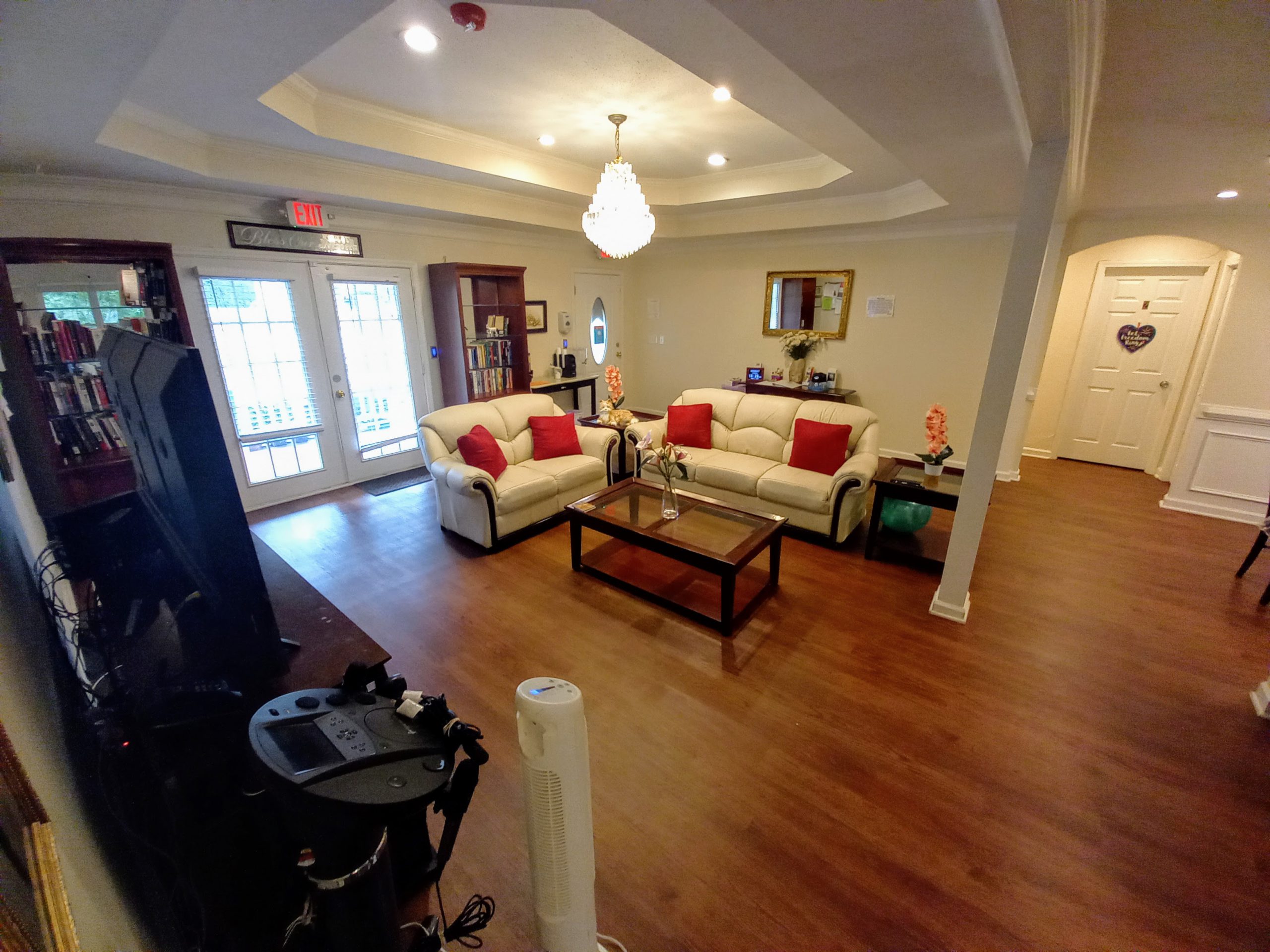 A living room with sofas and hardwood floors